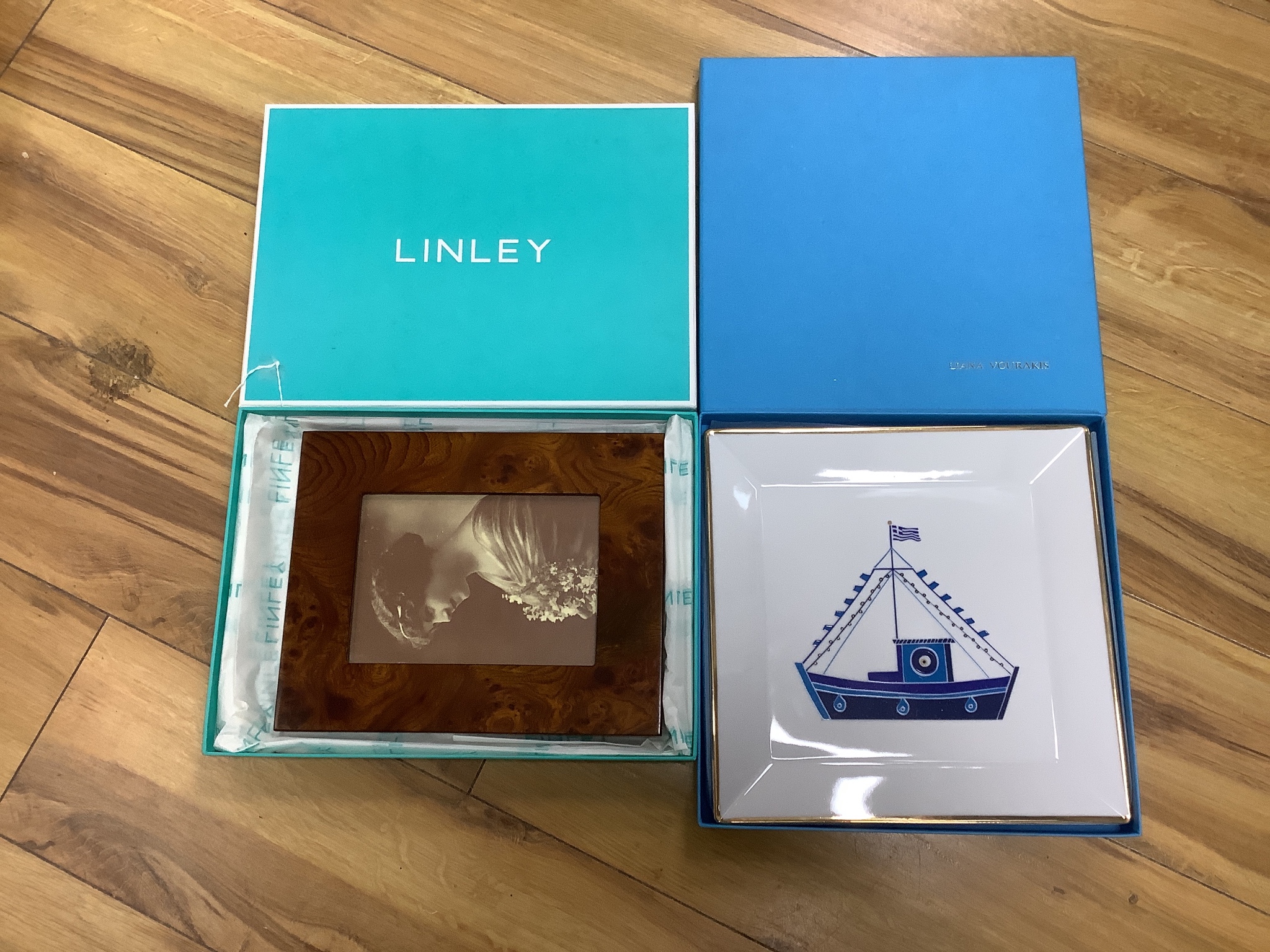 A boxed Elena Zournatzi for Liana Vourakis porcelain dish, decorated with a fishing boat, 27cm and a Ducci photograph frame in Linley box